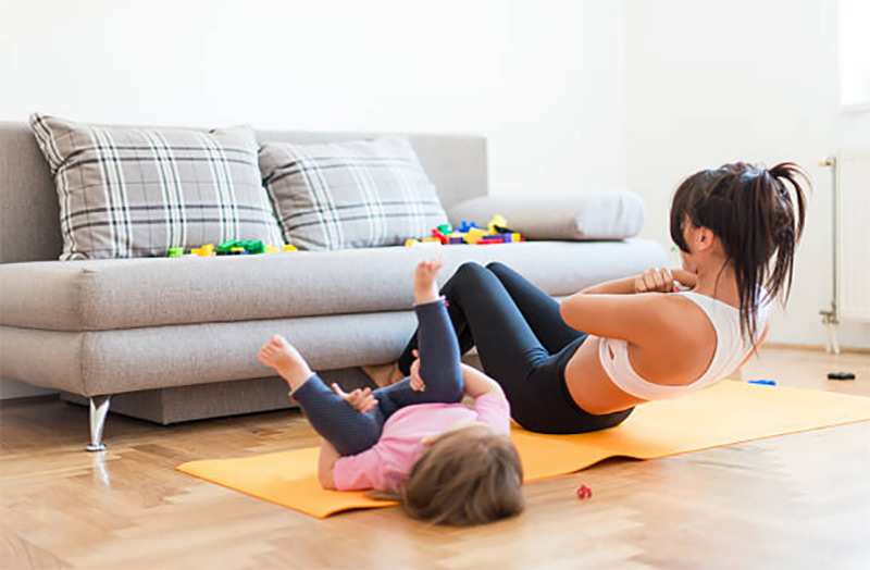 April health and wellness month - mom and toddler exercising